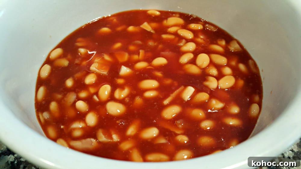 Classic Homestyle Baked Beans Recipe for Comforting Sides 4 bean ingredients poured into a casserole dish.
