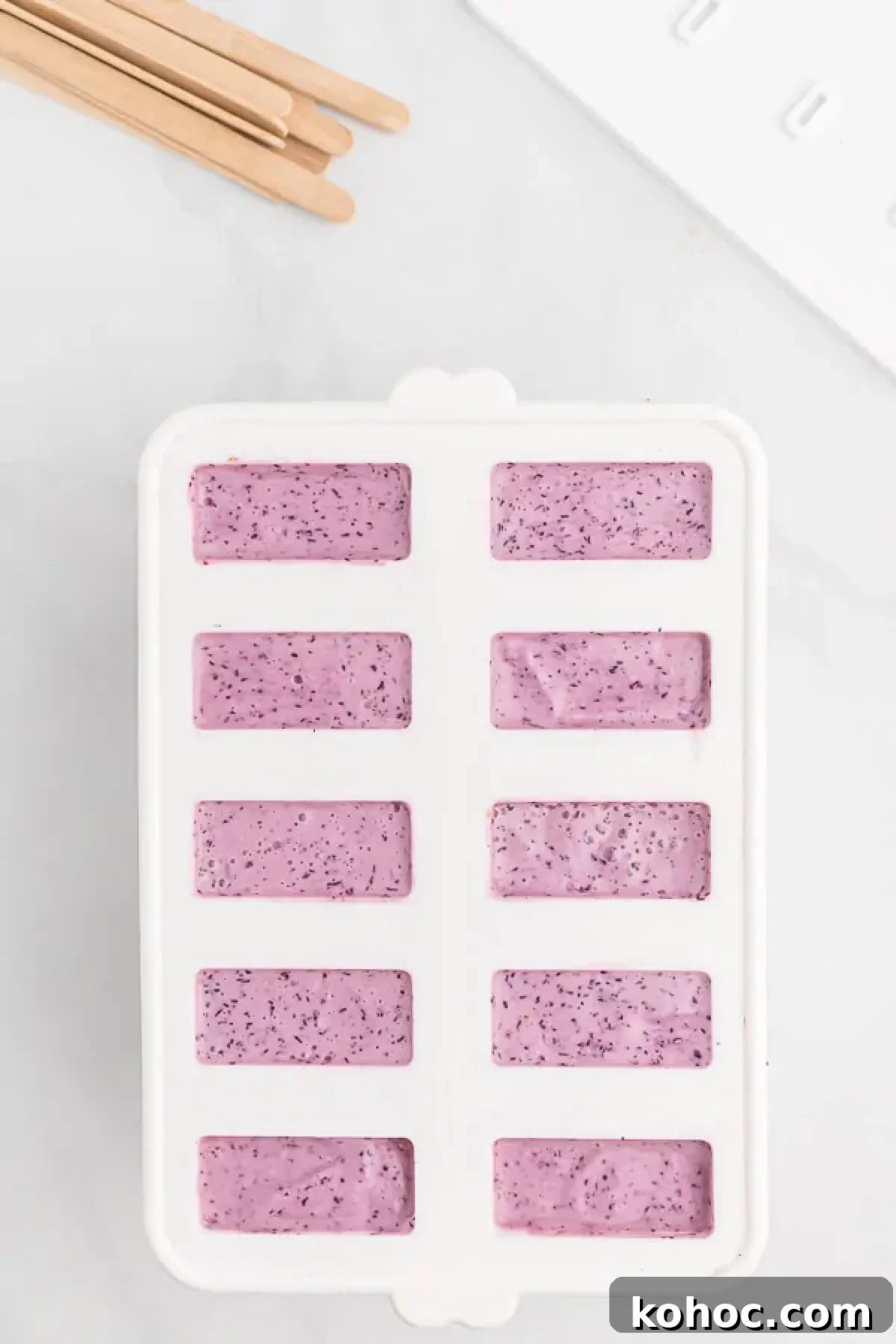 Creamy Blueberry Yogurt Popsicles Recipe for Summer 5 Mixture poured into molds.