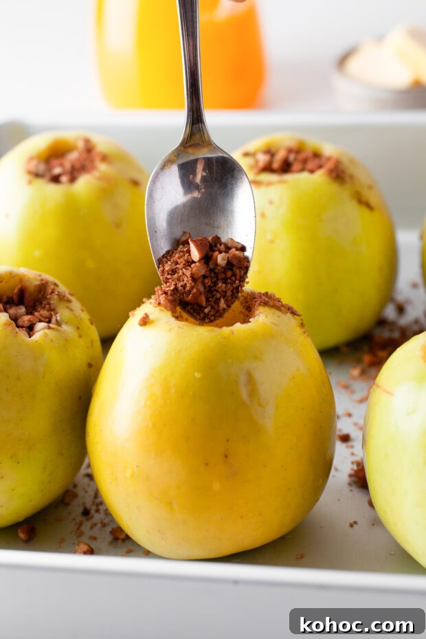 Cinnamon Baked Apples being filled with cinnamon and sugar. 