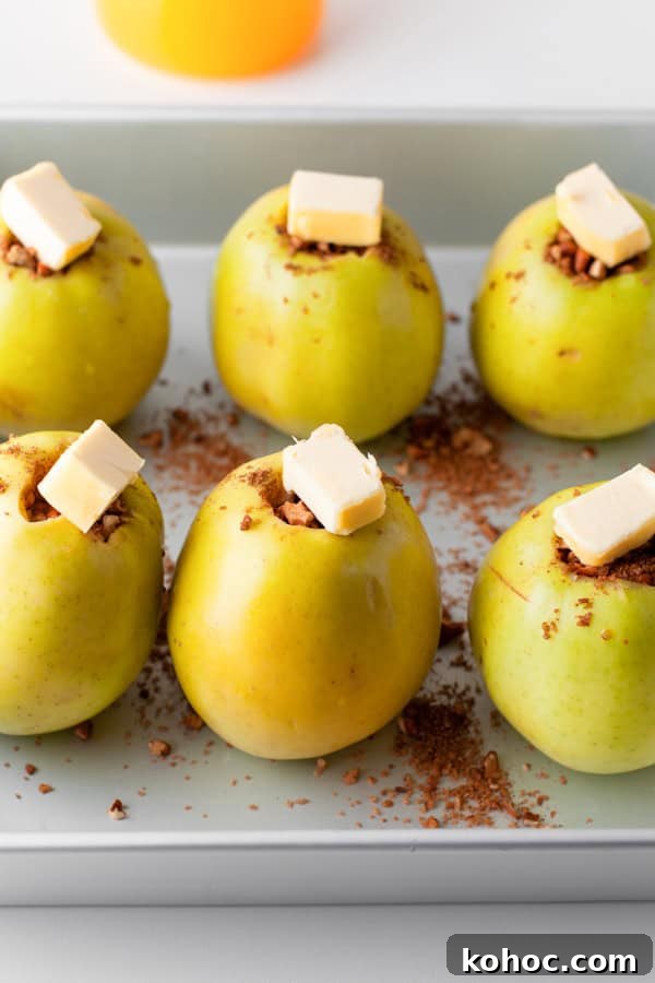 Cinnamon Baked Apples in a pan covered with butter. 