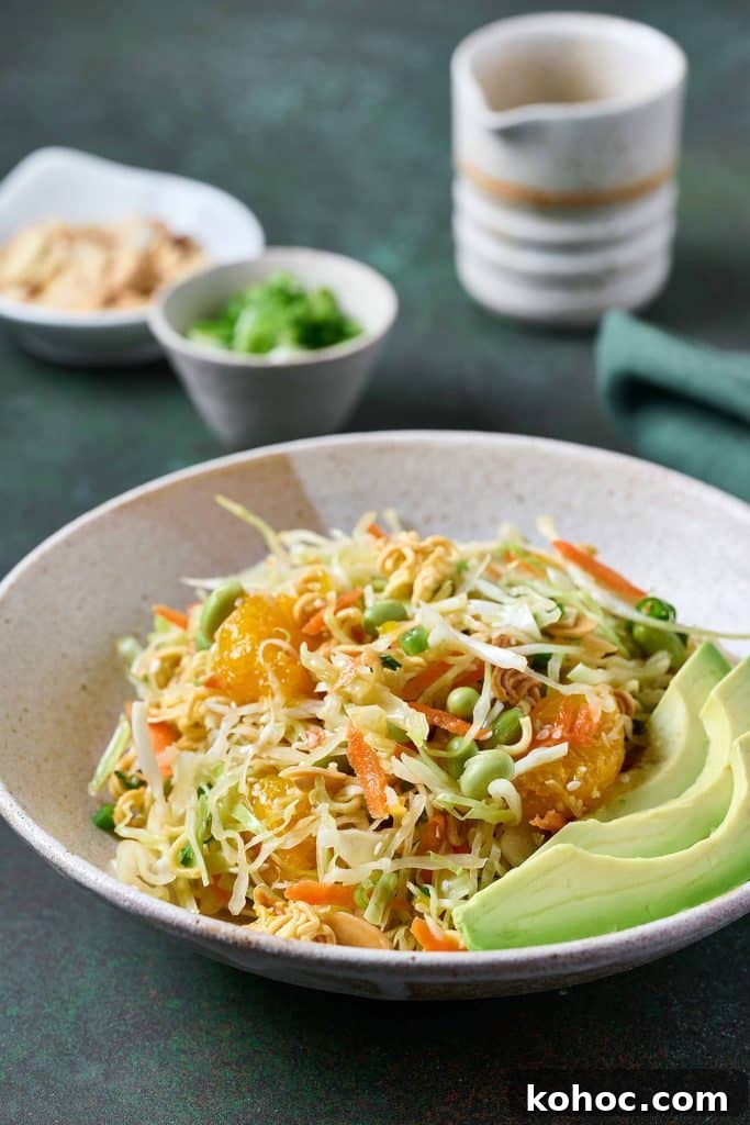 Crunchy Ramen Noodle Salad with Cabbage & Almonds 13 A serving of ramen salad in a bowl with sliced avocado.