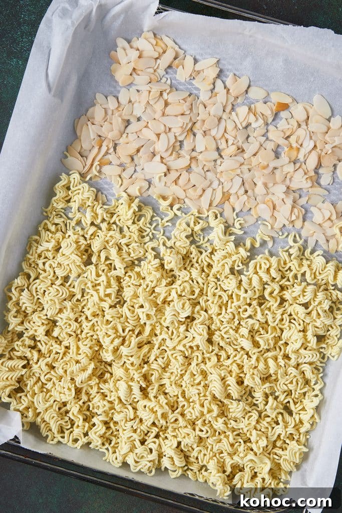 Crunchy Ramen Noodle Salad with Cabbage & Almonds 6 Crushed ramen noodles ans almond slivers on a sheet pan