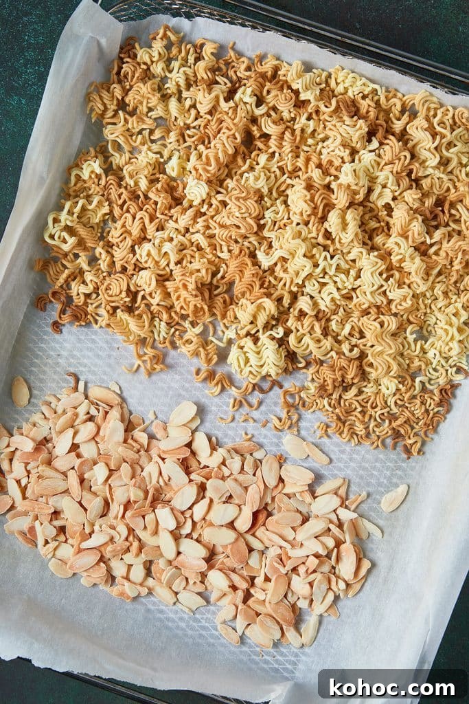Crunchy Ramen Noodle Salad with Cabbage & Almonds 7 Toasted ramen noodles and almonds on a sheet pan.