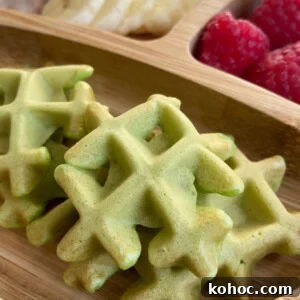 Green Spinach Banana Waffles Recipe | Fluffy & Nutritious Breakfast 7 Spinach banana waffles served with sliced bananas and raspberries