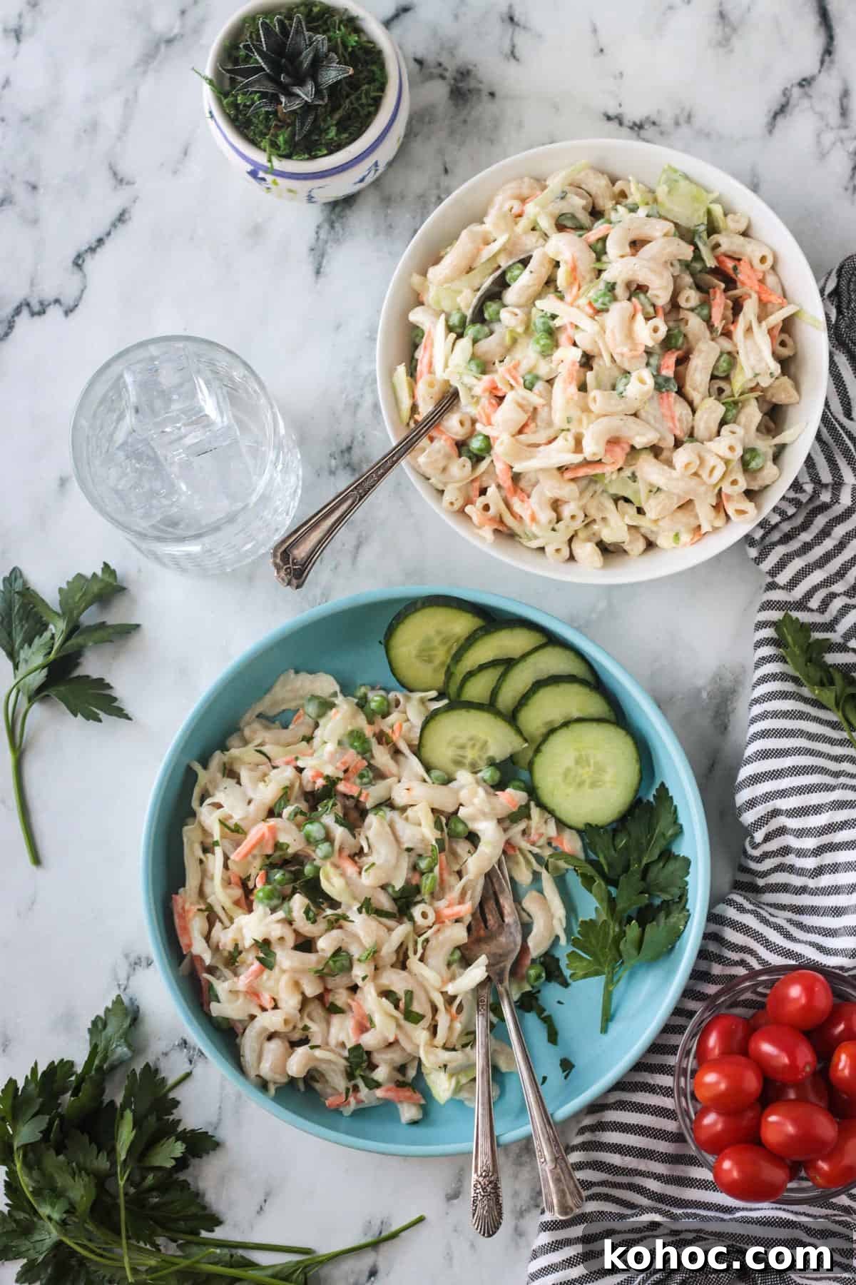 Creamy No-Chop Vegan Macaroni Salad for Quick Meals 8 Bowl of pasta salad next to a plate with a serving of the finished dish.