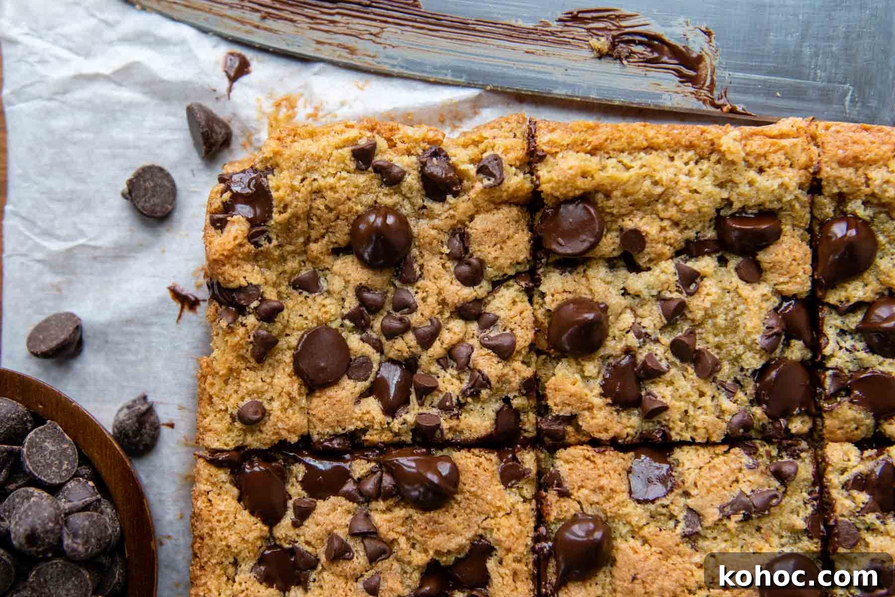 Almond Flour Blondies Recipe – Chewy Gluten-Free Treats 3 overhead shot of cut blondie bars with a knife laying next to it.