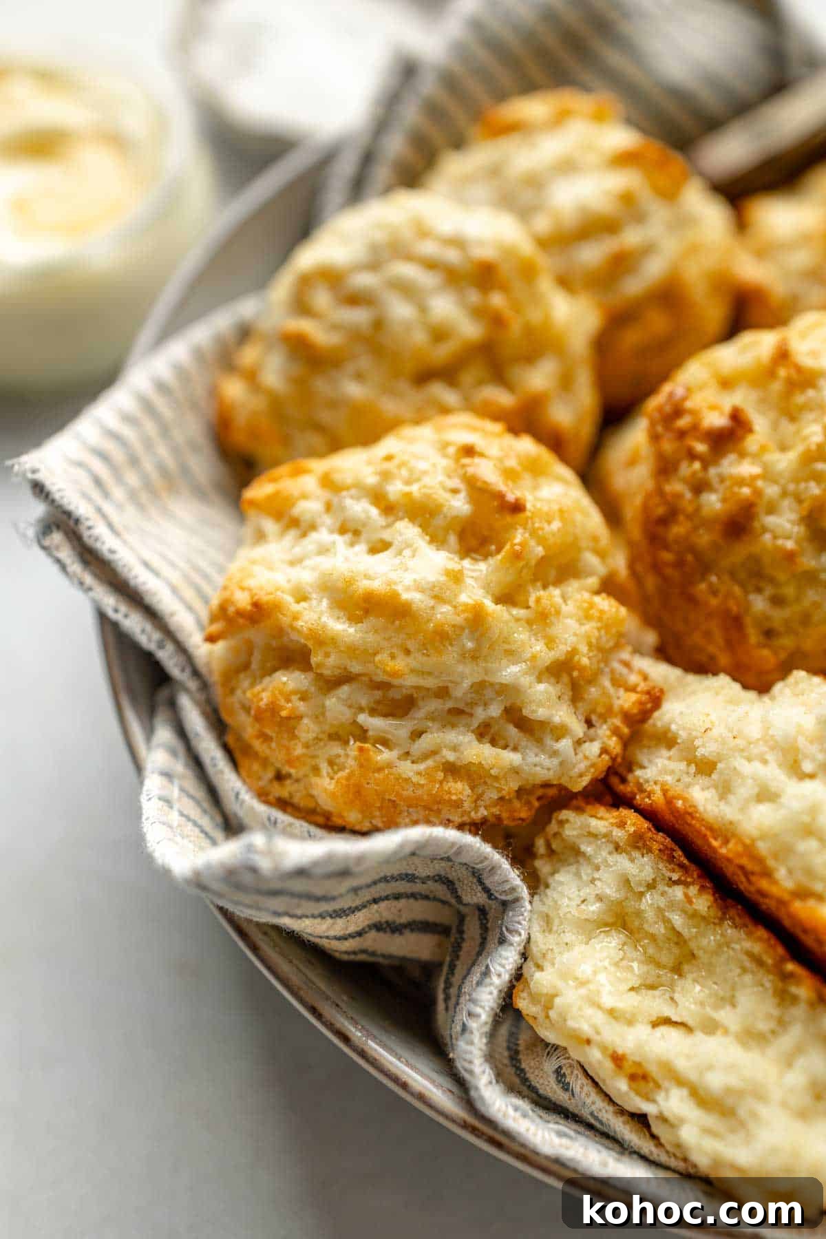 Tender Fluffy Gluten-Free Drop Biscuits Recipe for Perfect Results 6 Gluten-free drop biscuits in bowl lined with striped towel.