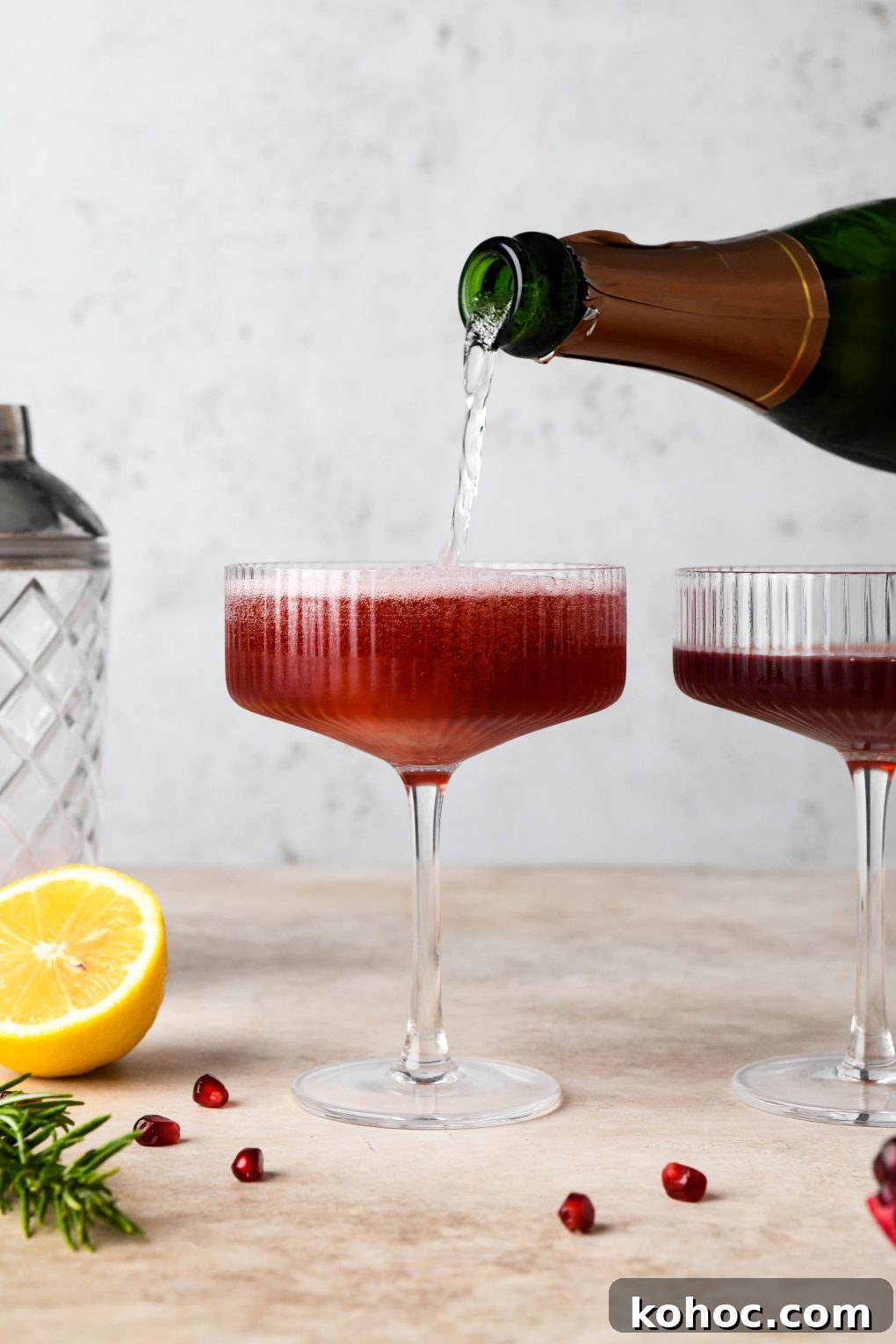 Pomegranate Champagne Cocktail with Gin or Vodka for Holidays 12 How to make Festive Pomegranate Champagne Cocktail: Pouring champagne into the champagne coupes