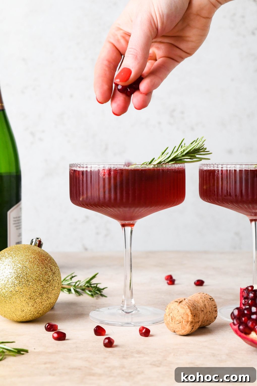 Pomegranate Champagne Cocktail with Gin or Vodka for Holidays 14 How to make Festive Pomegranate Champagne Cocktail: Dropping pomegranate seeds into the cocktail