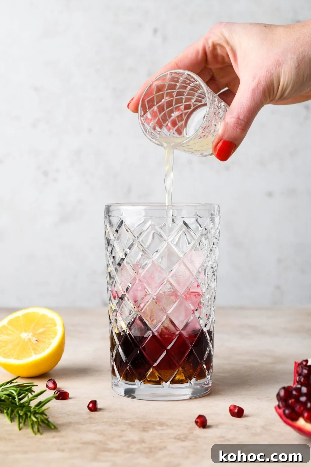 Pomegranate Champagne Cocktail with Gin or Vodka for Holidays 8 How to make Festive Pomegranate Champagne Cocktail: Pouring the lemon juice into cocktail shaker.