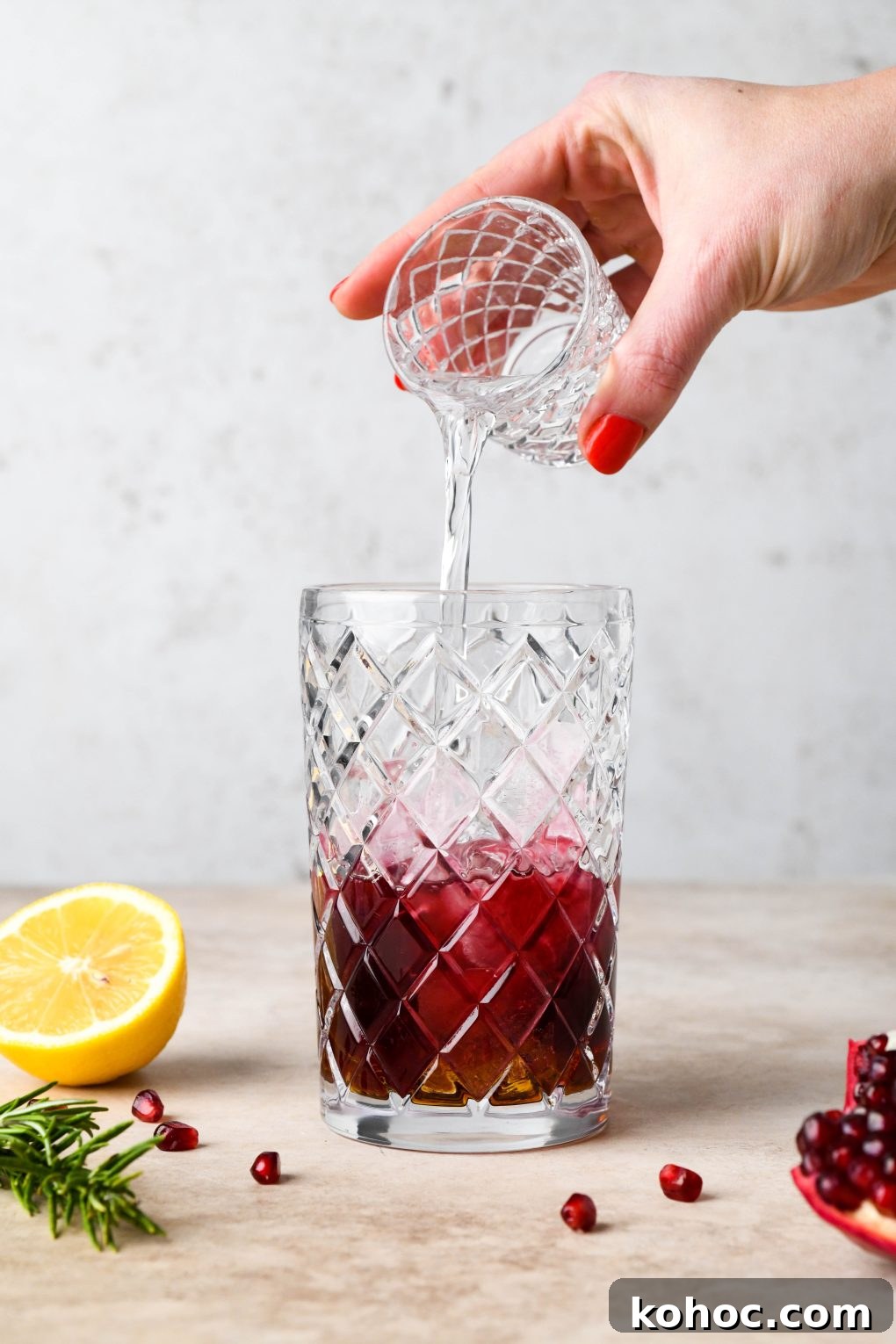 Pomegranate Champagne Cocktail with Gin or Vodka for Holidays 9 How to make Festive Pomegranate Champagne Cocktail: Pouring the vodka into cocktail shaker.