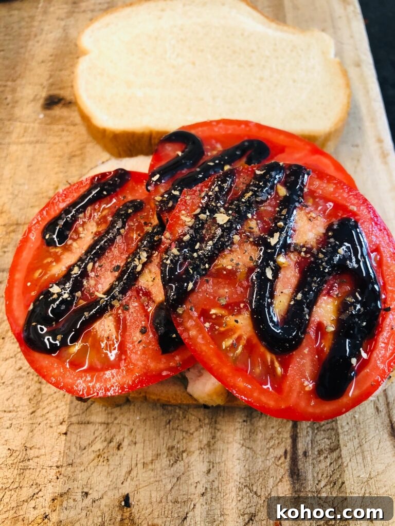 Caprese Chicken Panini Recipe: Melty Tomato, Basil & Mozzarella 4 tomatoes on sandwich with balsamic glaze drizzled over top for chicken caprese paninis
