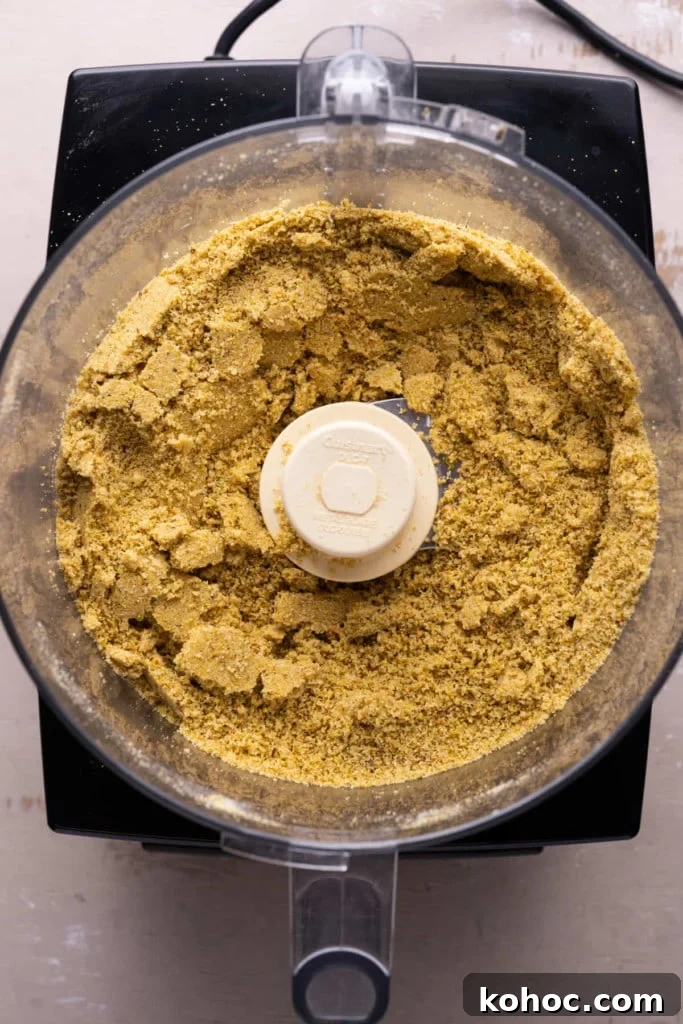 Using a food processor to combine pistachios with granulated sugar.