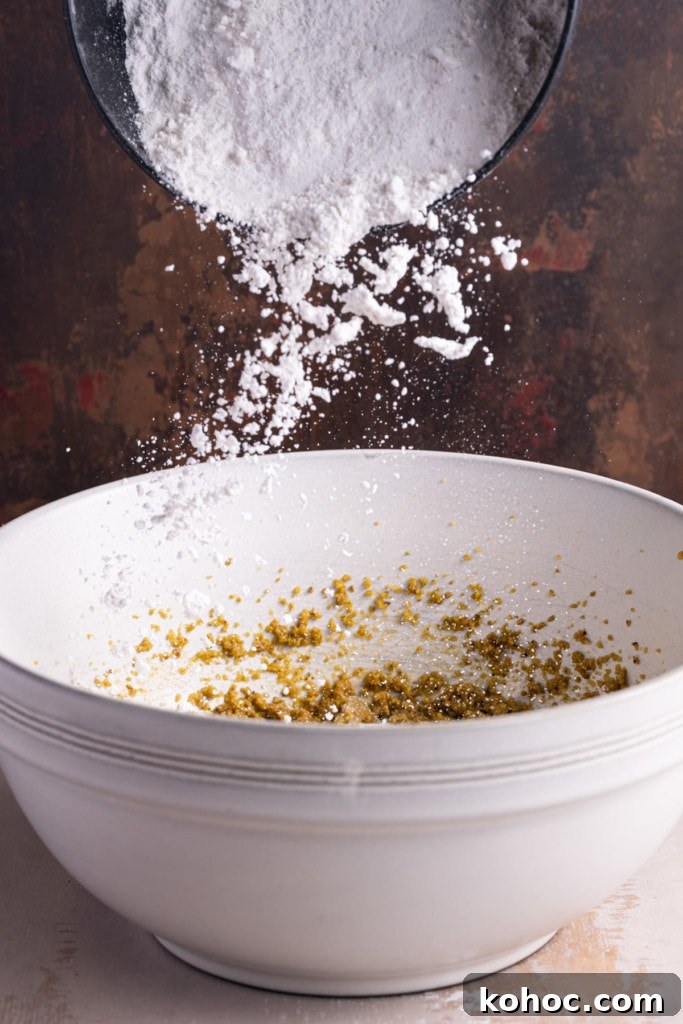 Adding dry ingredient to muffin batter.