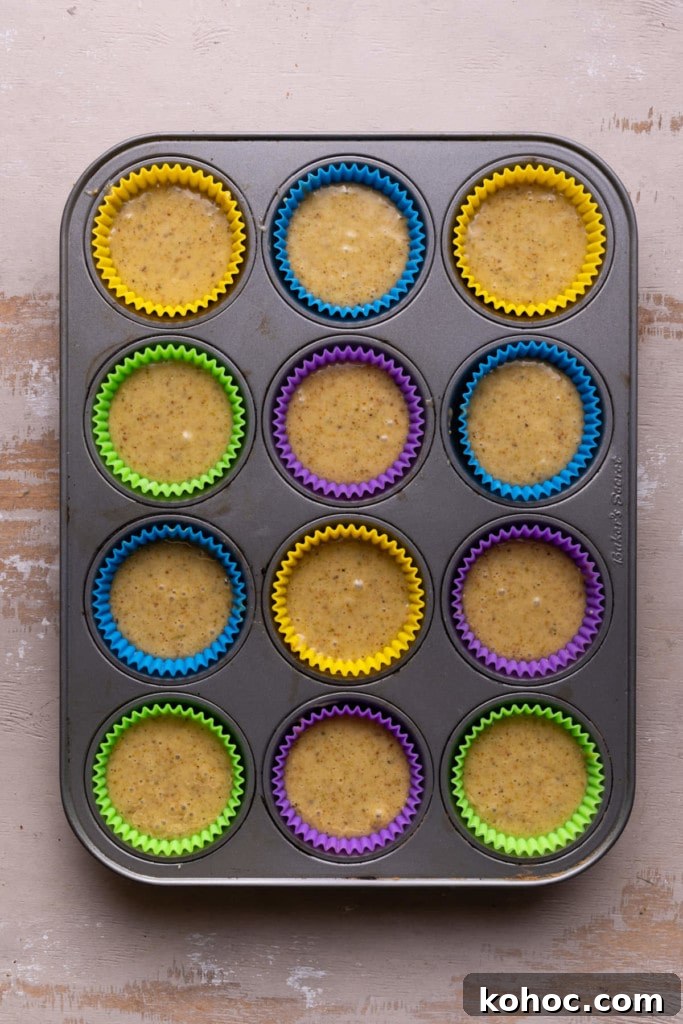 Filling muffin cups with batter.