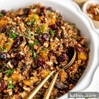 Quinoa with cranberries and nuts in a white bowl.