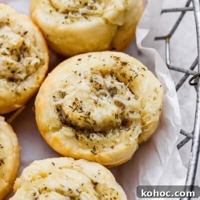 Savory pastry rolls topped with cheese and herbs.