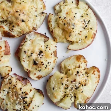 Smashed red potatoes on a plate.