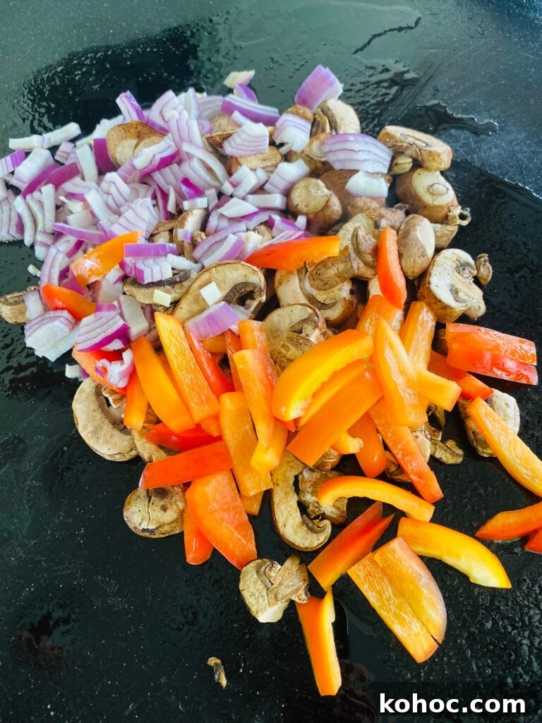 sliced peppers and onions and the griddle before cooking