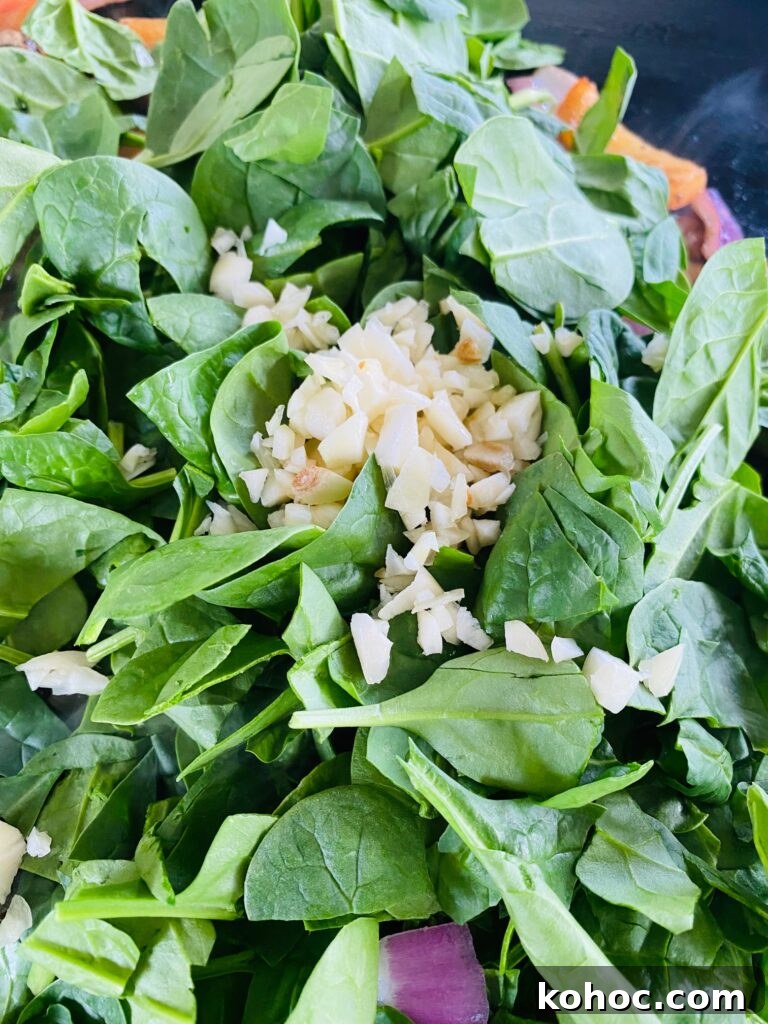 adding the spinach and garlic