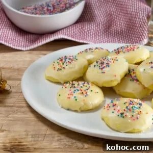 Italian anise cookies decorated with nonpareil sprinkles on a white plate