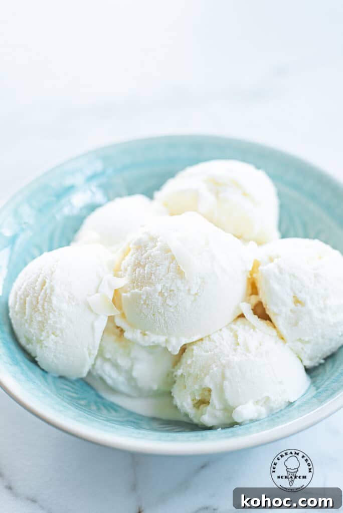 Creamy Homemade Coconut Sorbet Recipe 6 scoops of coconut sorbet in a blue bowl