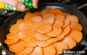 Curried Beef Mince Hotpot Recipe for Comforting Family Dinners 10 Spray oil being sprayed all over the sweet potato slices