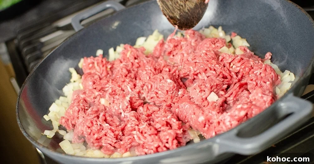 Curried Beef Mince Hotpot Recipe for Comforting Family Dinners 14 Chopped onion and mince meat cooking in a cast iron dish