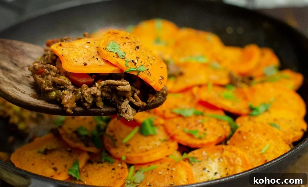 Curried Beef Mince Hotpot Recipe for Comforting Family Dinners 24 Curried Mince Hotpot with sweet potato being served up with a wooden spoon
