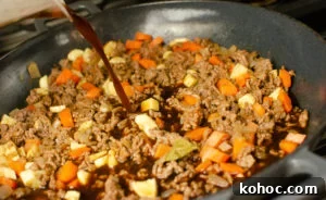 Curried Beef Mince Hotpot Recipe for Comforting Family Dinners 6 Beef stock being added to the dish to make mince hotpo