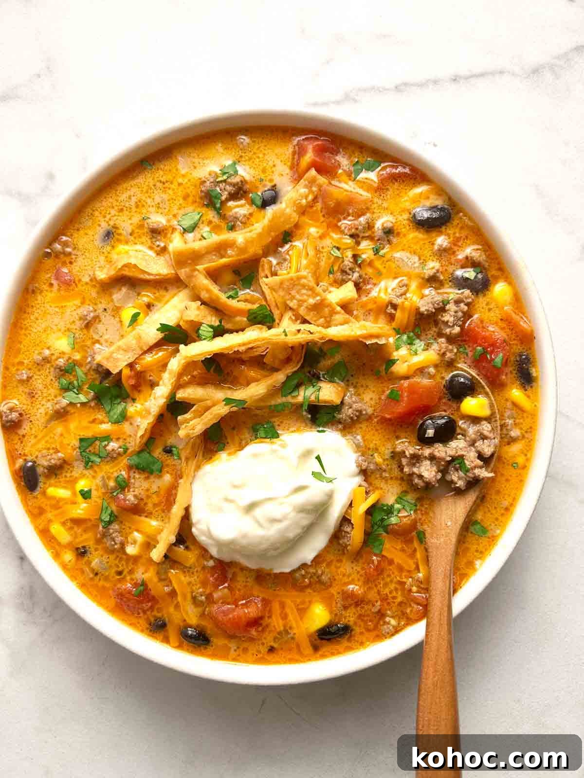 Creamy Chicken Taco Soup Recipe for Cozy Weeknight Meals 2 bowl of taco soup with sour cream, cilantro, and cheese added on top.
