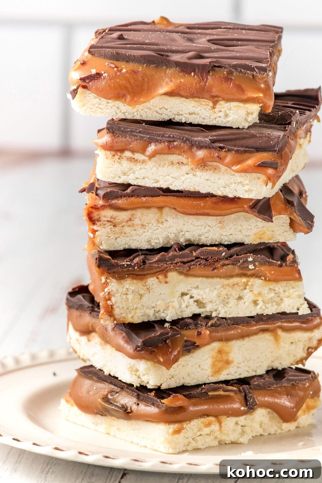 Low-Carb Millionaire Bars: Gooey Sugar-Free Caramel Treat 4 A stack of keto-friendly millionaire bars stacked on a white plate