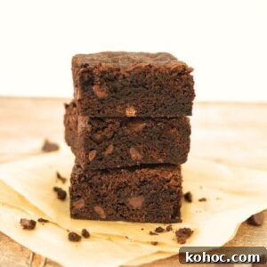 15+ Decadent Chocolate Sourdough Recipes to Try 30 A stack of 3 sourdough brownies showing the crispy top and fudgy inside.