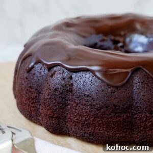 15+ Decadent Chocolate Sourdough Recipes to Try 31 Close up of sourdough chocolate bundt cake topped with glossy chocolate ganache.