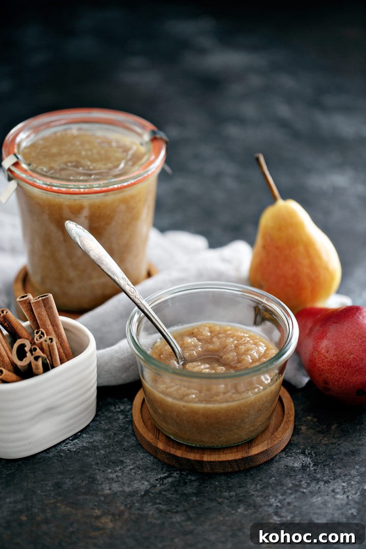 Homemade Pear Sauce Recipe: Smooth, Sweet, and Simple 4 jar of homemade pear sauce with a spoon in it next to fresh pears