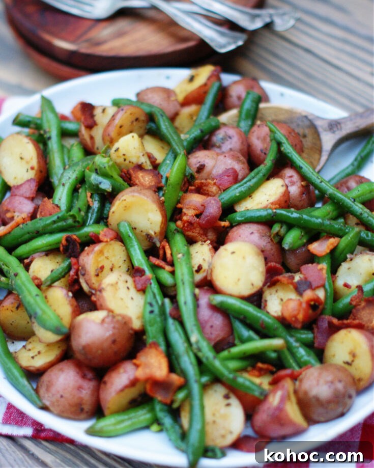country style fresh green beans and new potatoes with crumbled bacon as a vegetable side dish