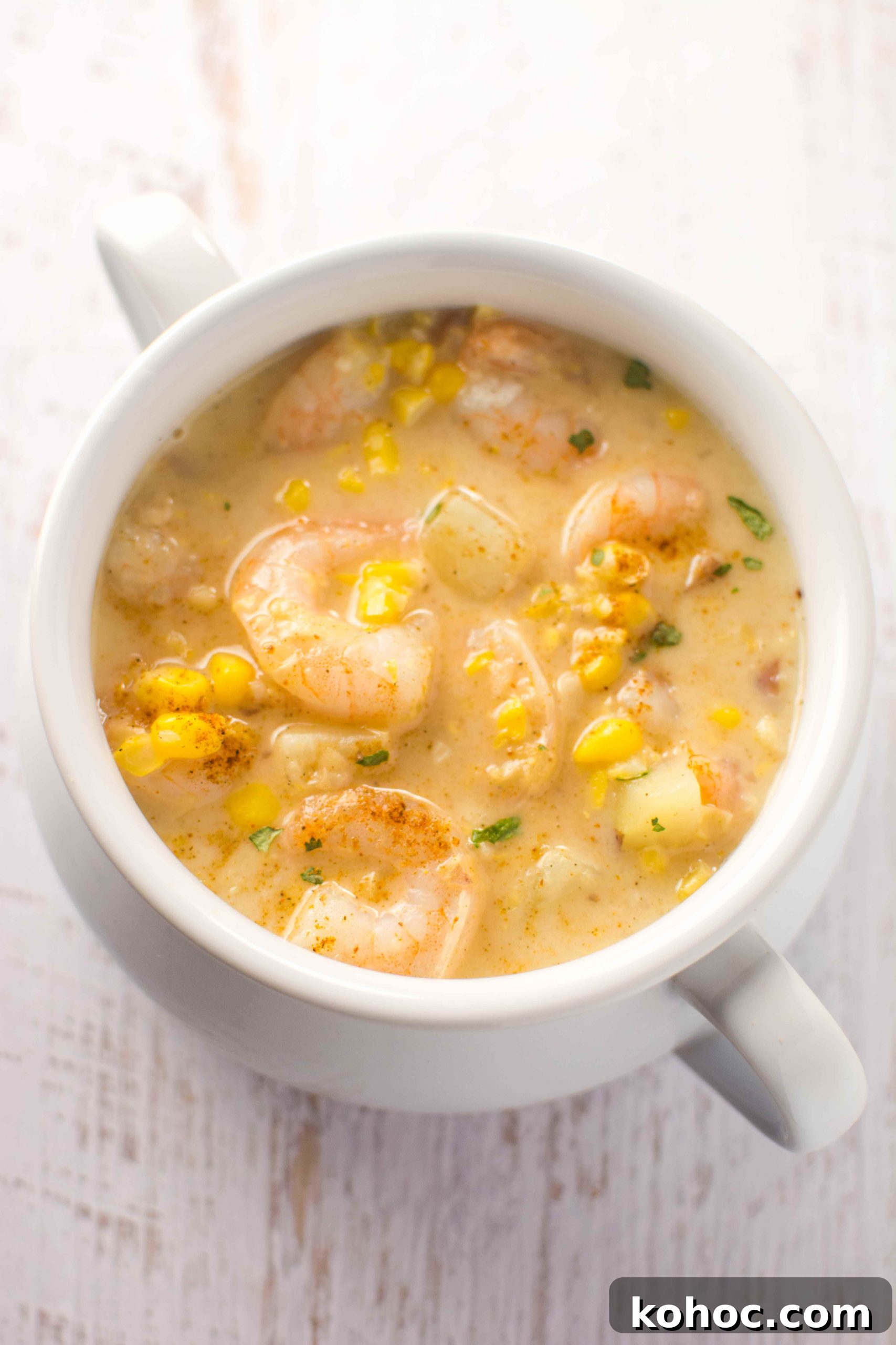 Cajun Shrimp and Corn Chowder (Slow Cooker Recipe) 4 white bowl filled with cajun corn and shrimp chowder