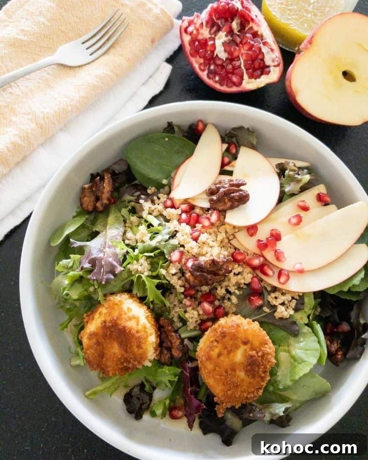 bowl full of harvest salad with two fried goat cheese balls