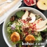 fall salad topped with fried goat cheese balls