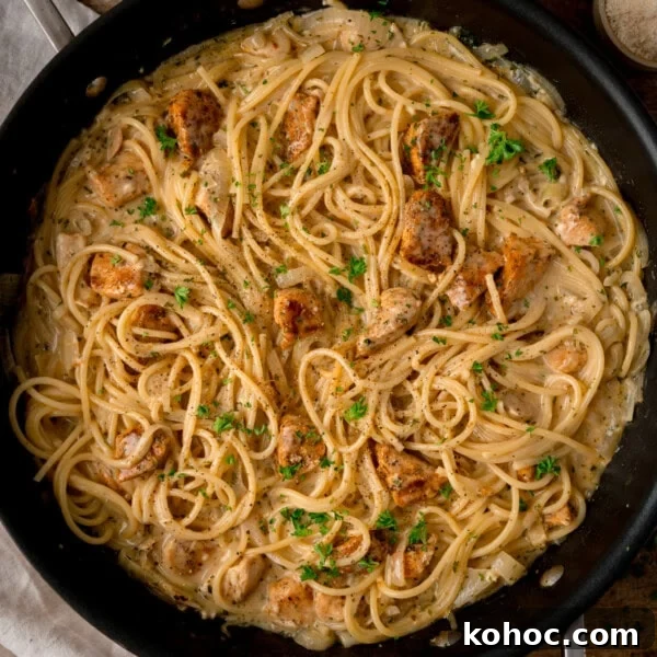 Skillet with creamy Garlic Butter Chicken Pasta.