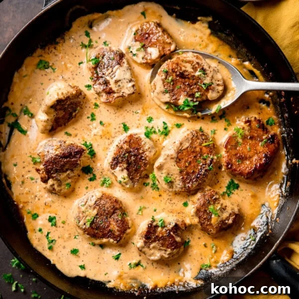 Pan of seared pork medallions in creamy Dijon sauce.