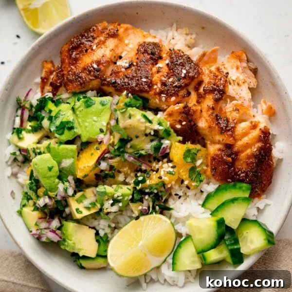 Bowl with spiced salmon and avocado orange salad.