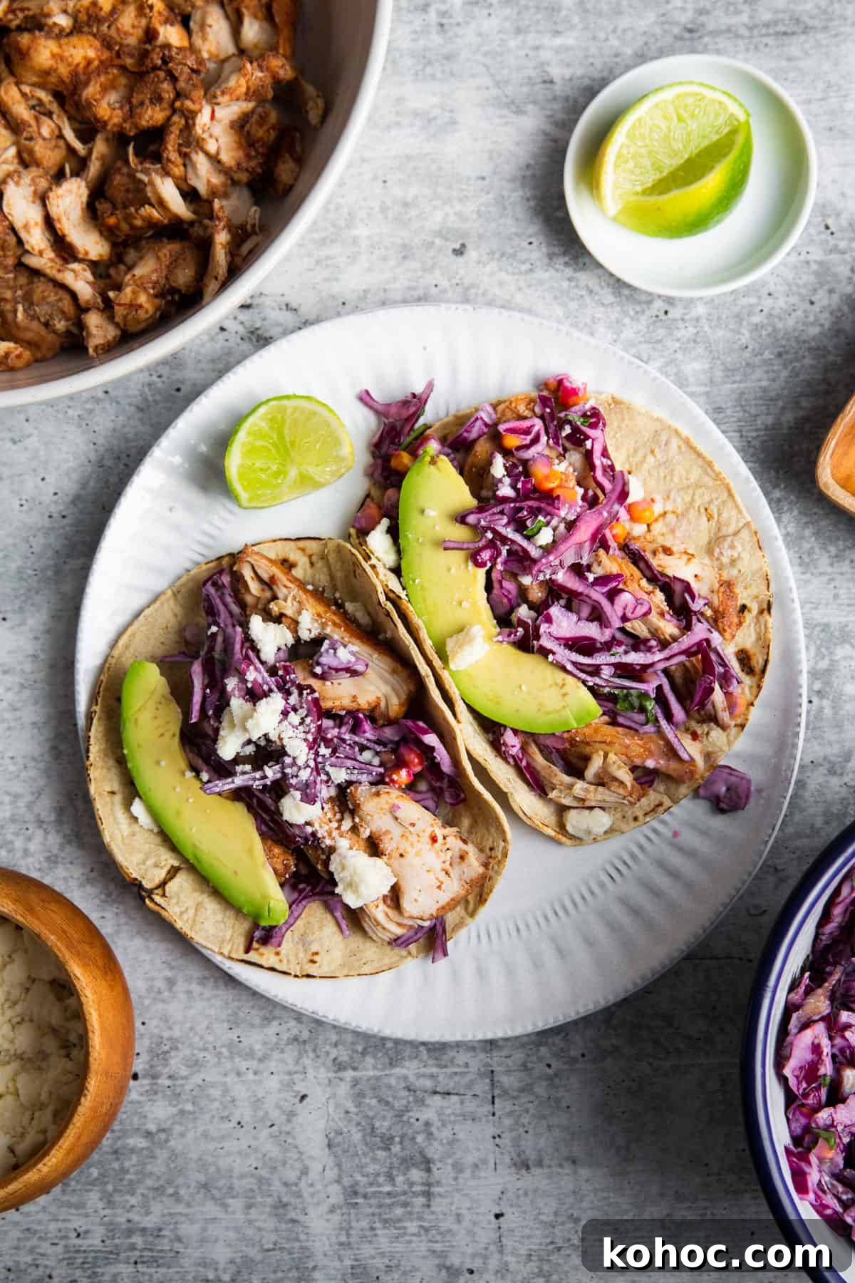 Slow-Cooker Shredded Chipotle Chicken Recipe for Tacos & Bowls 2 two tortillas filled with slow cooker shredded chipotle chicken