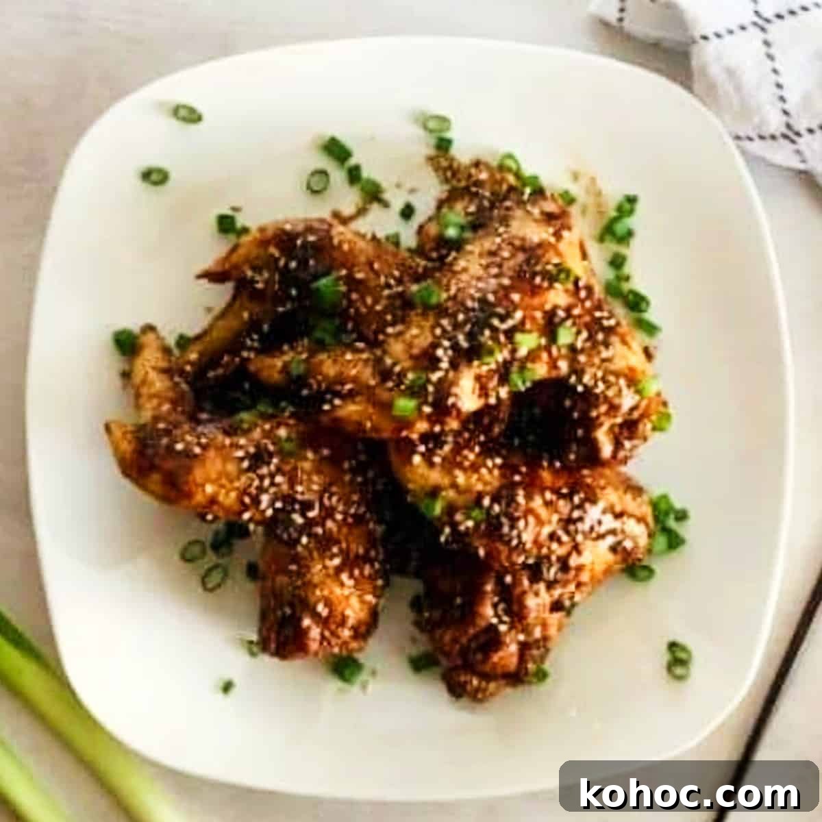Crispy Oven-Baked Asian-Style Chicken Wings for Game Night 3 baked chicken wings with asian sauce.