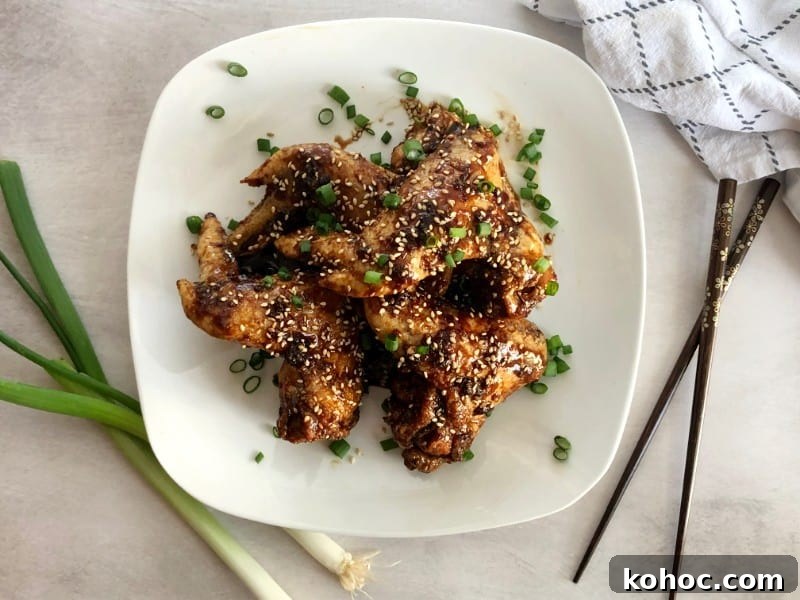 Crispy Oven-Baked Asian-Style Chicken Wings for Game Night 10 baked asian chicken wings with green onion and sesame seeds