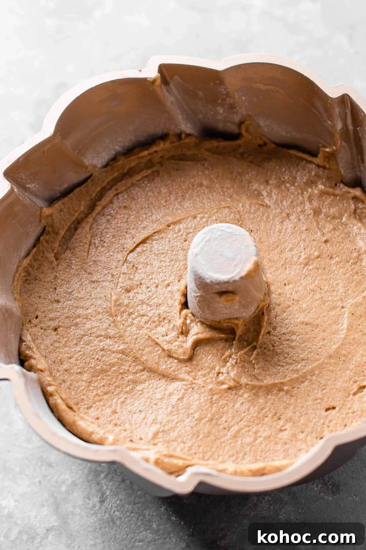 Caramel Gingerbread Cake with Silky Whipped Caramel Icing 9 caramel gingerbread cake batter spread into Bundt pan