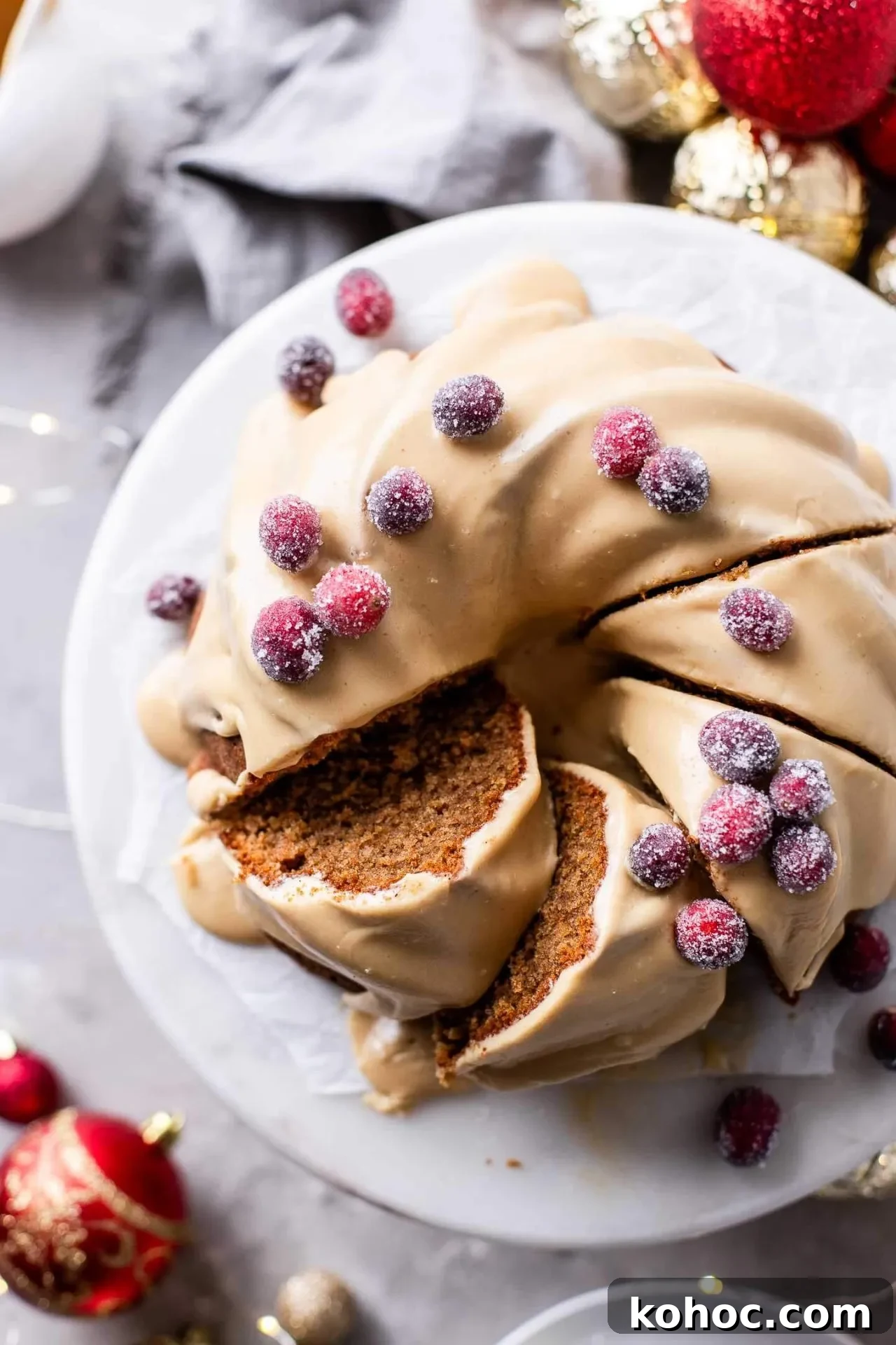 Caramel Gingerbread Cake with Silky Whipped Caramel Icing 3 frosted caramel gingerbread cake decorated with sugared cranberries on cake stand (6)