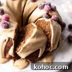 frosted caramel gingerbread cake decorated with sugared cranberries on cake stand (8)