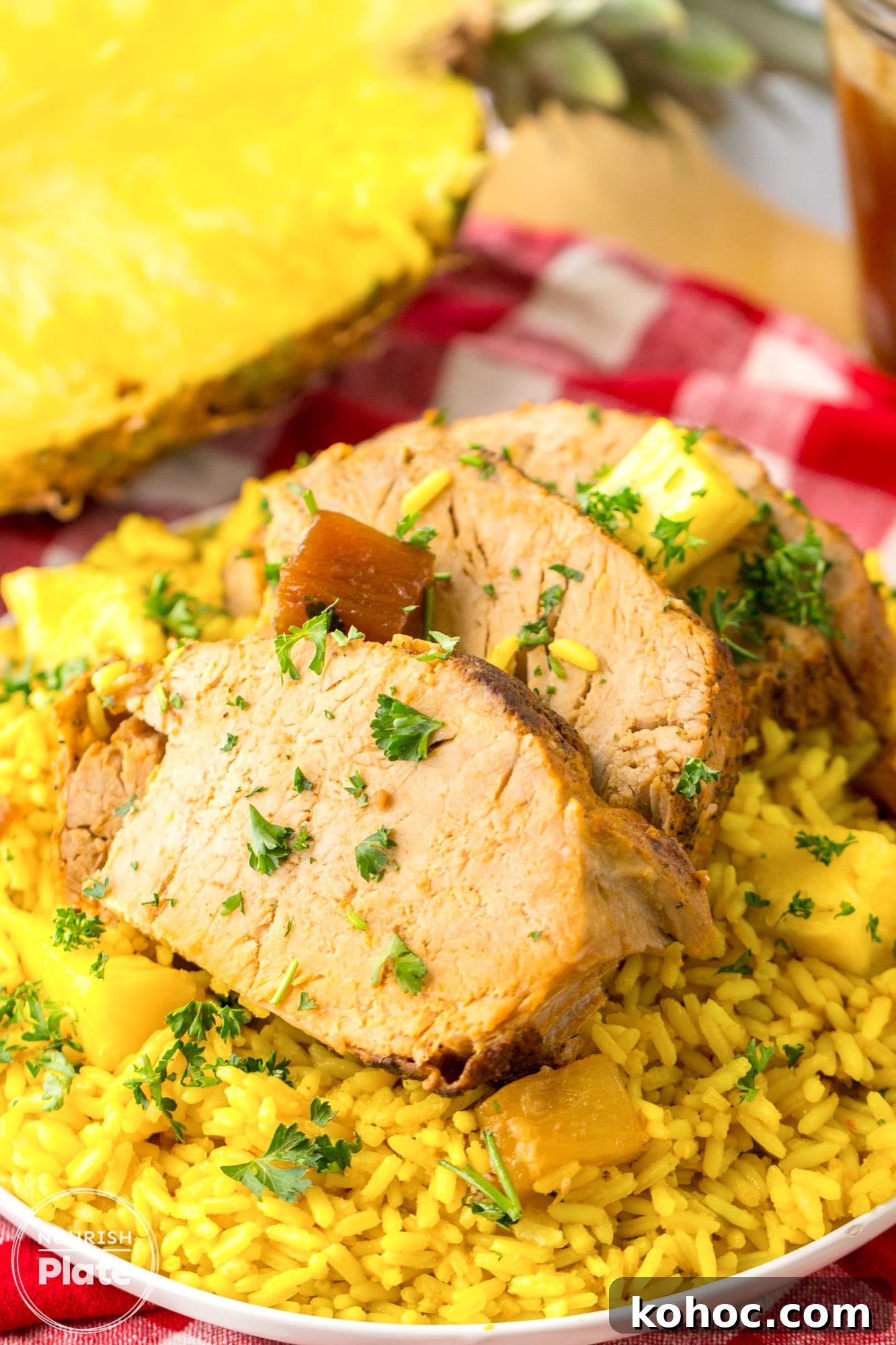 Pineapple Pork Loin Slow Cooker Recipe for Tender, Juicy Meat 5 Sliced pineapple pork loin served over yellow rice pilaf