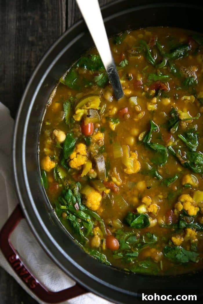Turmeric Vegetable and Wild Rice Broth Soup 3 Large Staub Dutch oven filled with turmeric broth and wild rice soup.